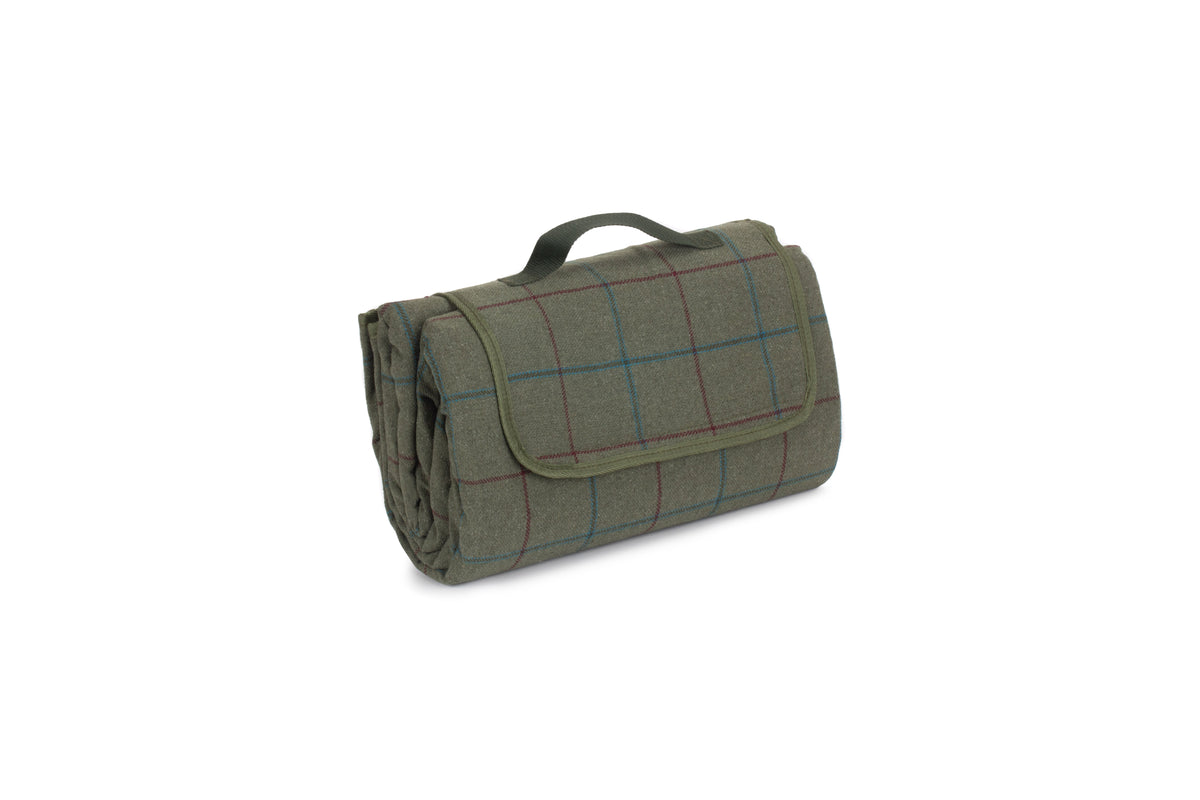 Roll-up green picnic blanket with checkered pattern on a white background