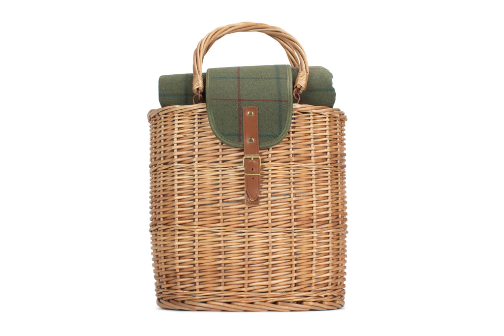 Wicker picnic basket with green lid and handle on a white background