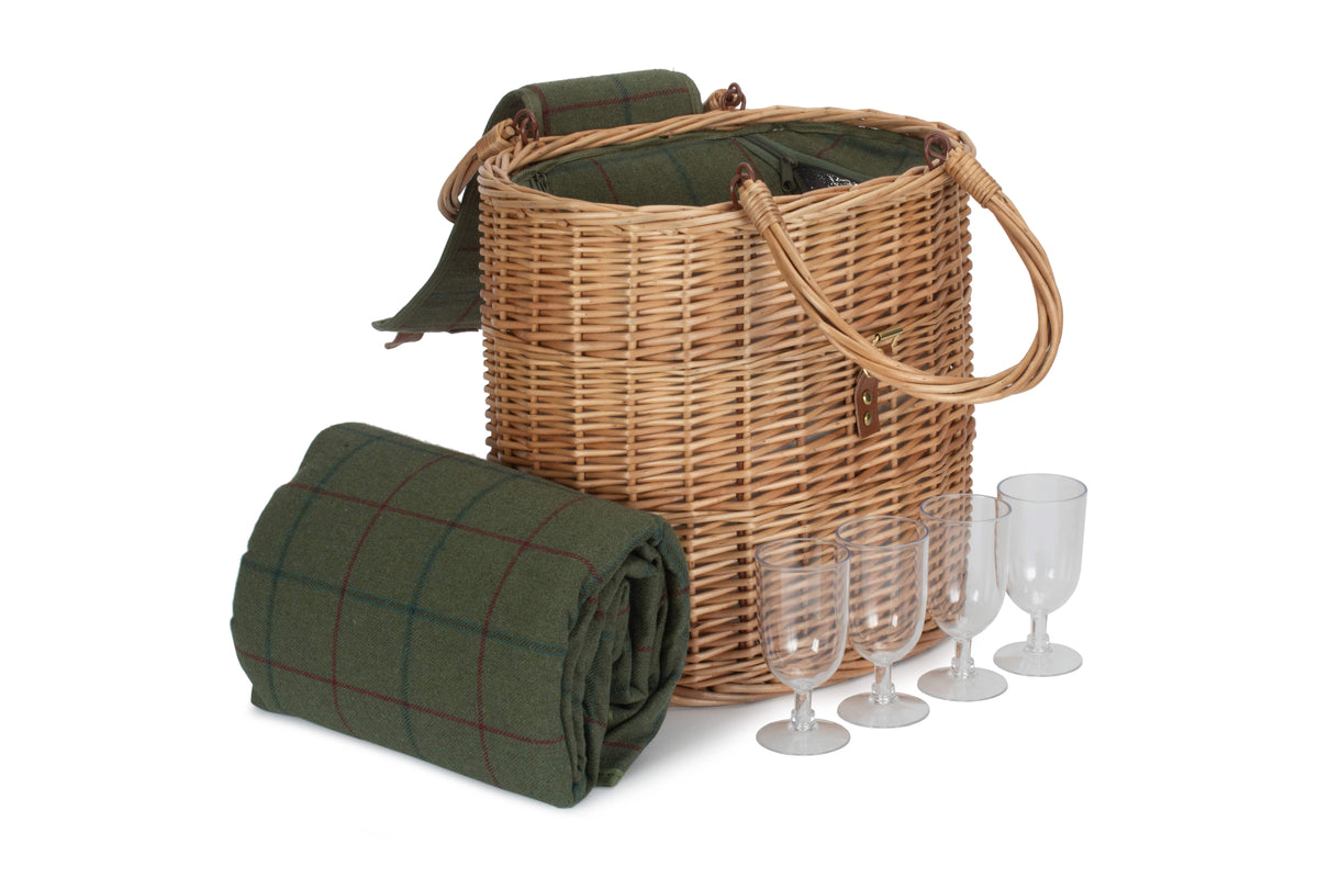 Wicker picnic basket with green plaid blanket and glasses on a white background
